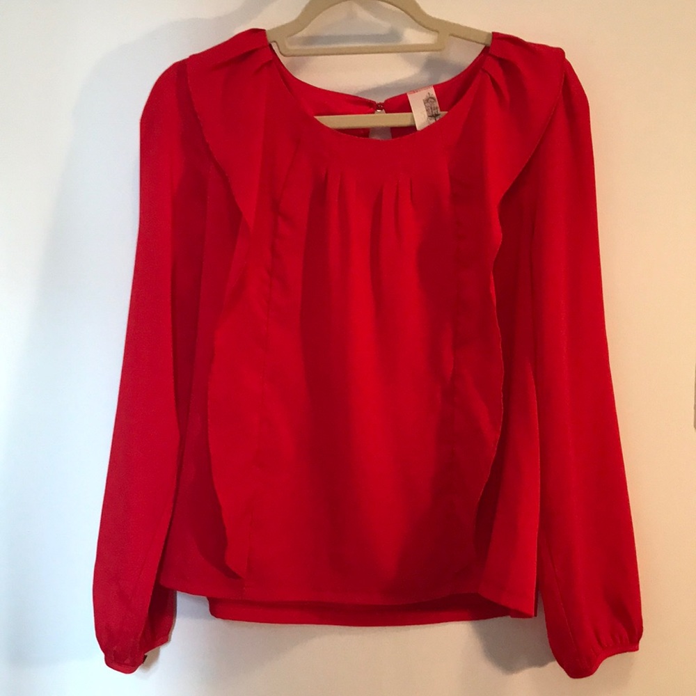 Francesca’s red ruffled blouse